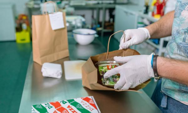 Cook packing takeaway food