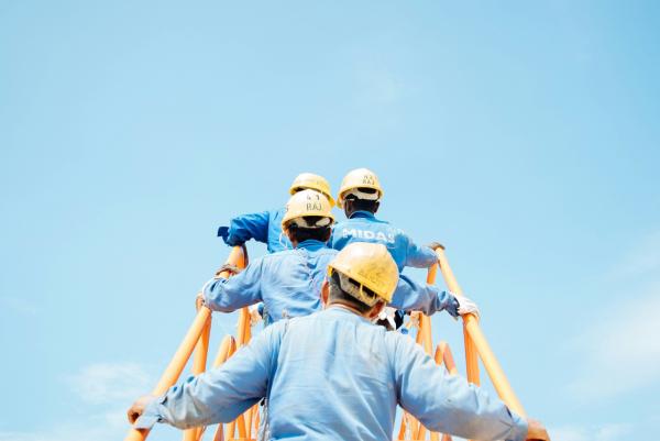 Builders walking up site stairs