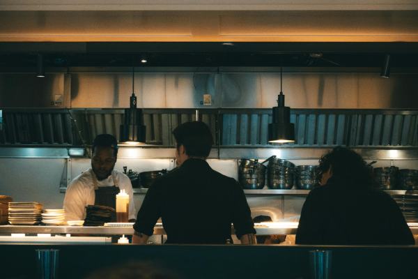 Busy kitchen pass in restaurant