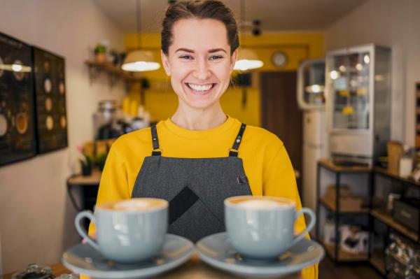 Smiling barista serving coffees