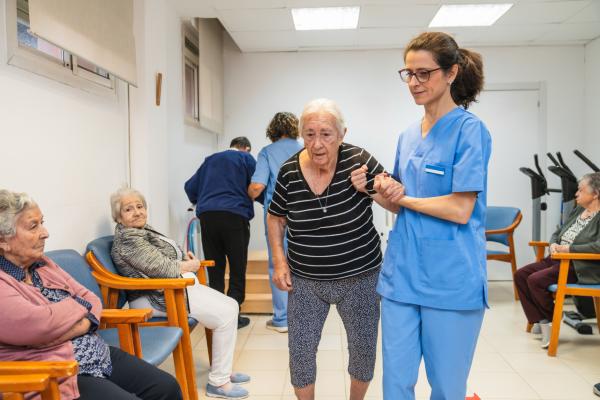 Nurse helping elderly woman