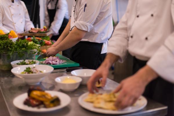Preparing meal in restaurant kitchen