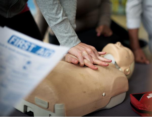 CPR training with chest compressions on a resuscitation mannequin - lifesaving first aid skills