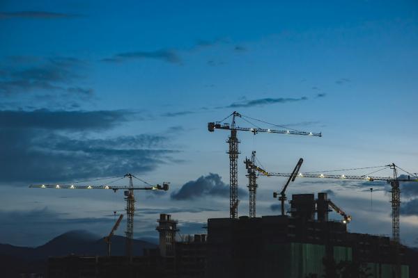 Cranes across evening skyline