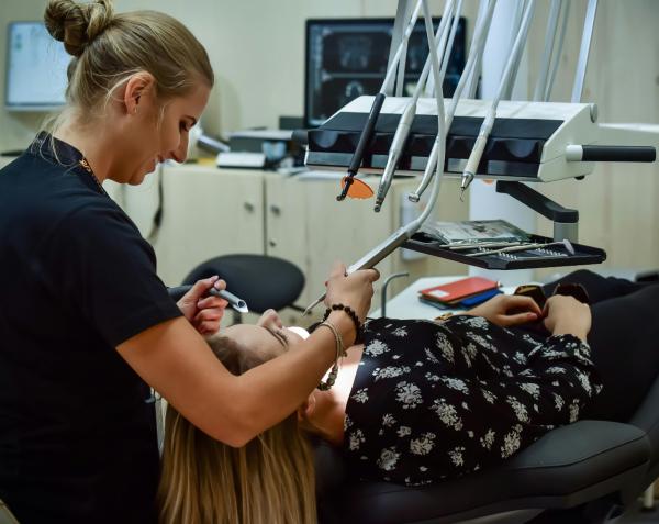 Dentist attending to her patient