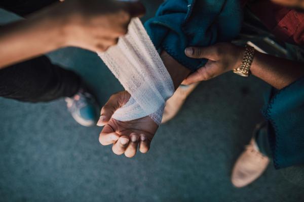 Man having hand bandaged