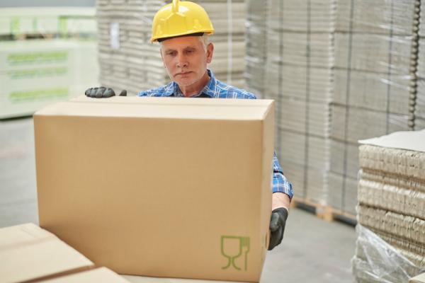 Man carrying box in warehouse