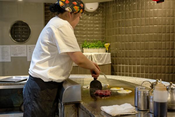 Chef preparing food on hot plate