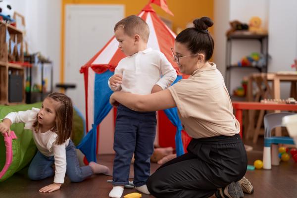 Kindergarten teacher playing with kids
