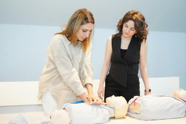 Woman learning CPR techniques